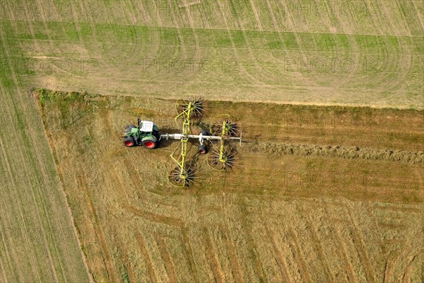 Tractor with hay rakes