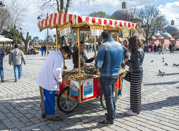 Salesman at his Sweet chestnut stall in Sultan Ahmed Park