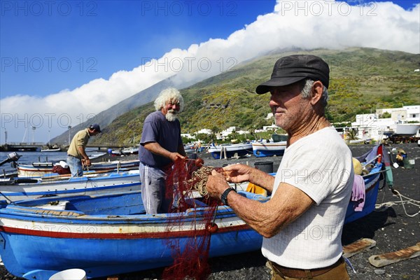 Fishermen repair nets at Scari Beach