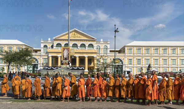 Row of monks in front of ministry of defense