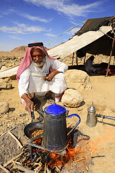 Bedouin preparing coffee with pan-roasted beans and kardamom