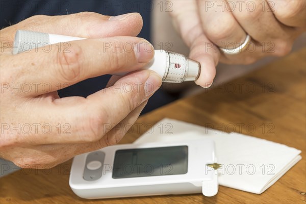 Diabetics taking a blood glucose test