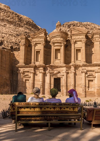 Tourists sitting on a bench