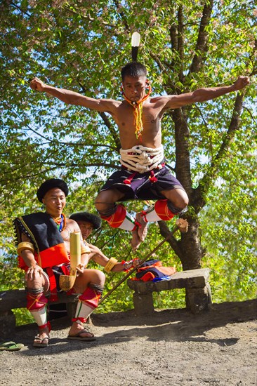 Naga tribal man in traditional outfit performing a warrior dance