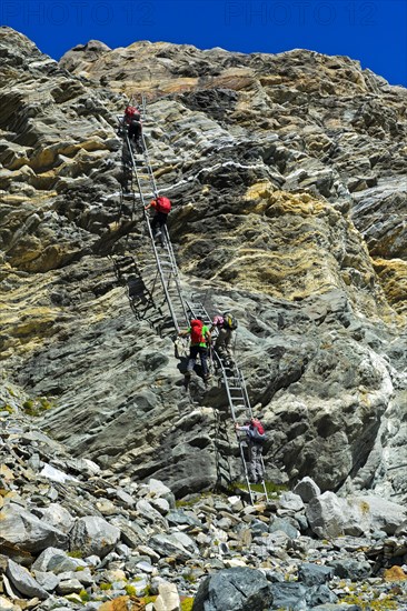 Alpine trail with metal ladders in the rock to the Monte Rosa hut