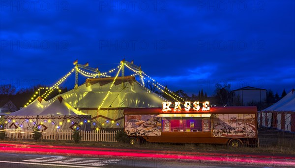 Travelling circus with counter illuminated at dusk