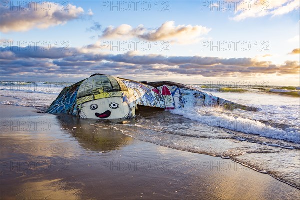 Colorfully painted bunker from the 2nd World War at high tide in the sea