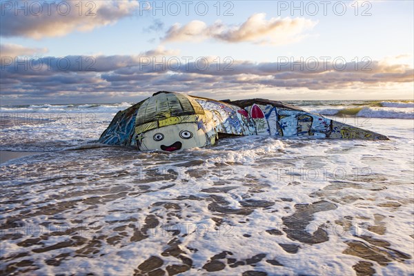 Colorfully painted bunker from the 2nd World War at high tide in the sea