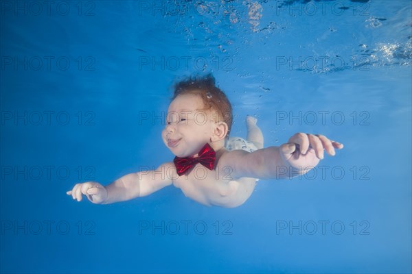 Baby boy diving in the pool