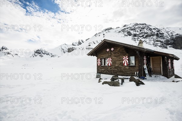 Traditional wooden chalet and snowy winter landscape