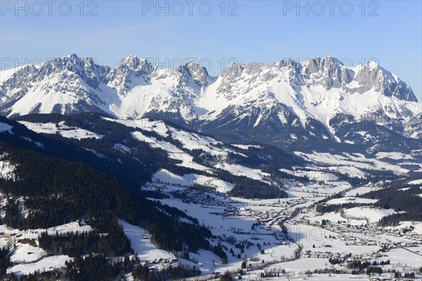 Snow-covered mountain massif Wilder Kaiser in winter with St. Johann in Tyrol
