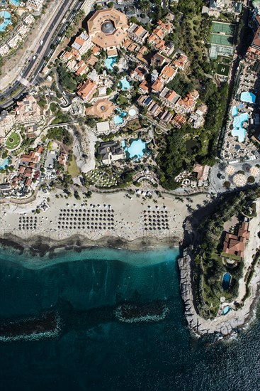 Beach with sunshades and waterfront resort with Iberostar El Mirador Gran Hotel