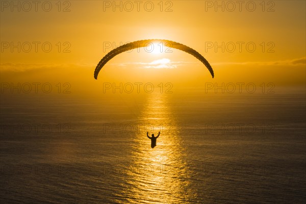 Paraglider over the Atlantic near Puerto Naos during sunset