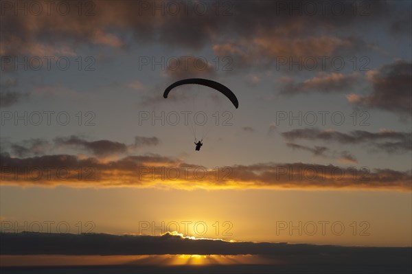 Paragliding over the Atlantic near Puerto Naos during sunset