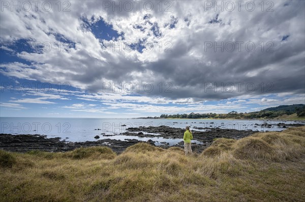 Middle-aged woman standing on the coast of East Cape