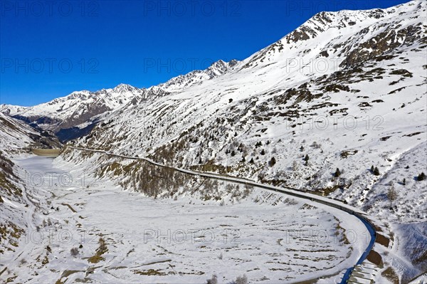 Covered country road on the snow-covered Lac des Toules reservoir in front of the Great St. Bernhard Tunnel