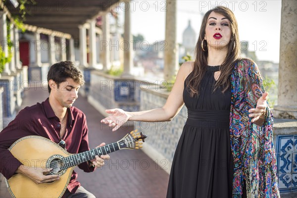 Band performing traditional music fado under pergola with portuguese tiles called azulejos in Lisbon