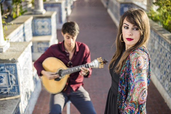 Band performing traditional music fado under pergola with portuguese tiles called azulejos in Lisbon