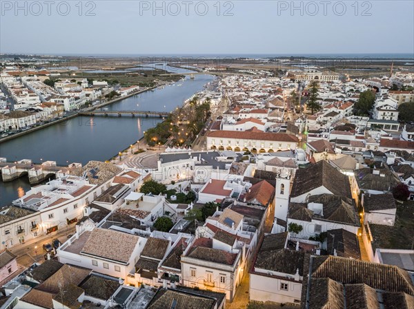 City view with roman bridge over Gilao river in old fishermen's town in the evening light