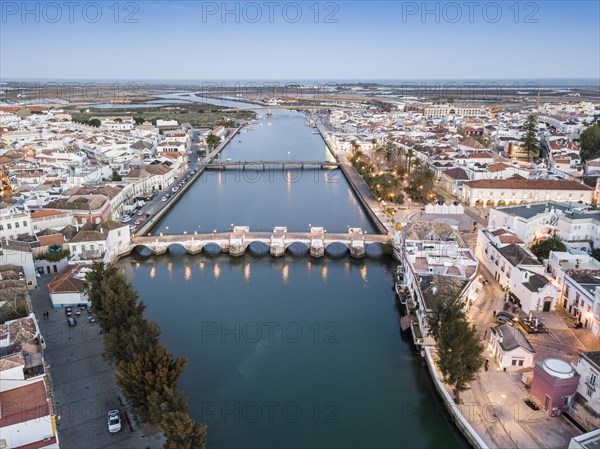 City view with roman bridge over Gilao river in old fishermen's town in the evening light