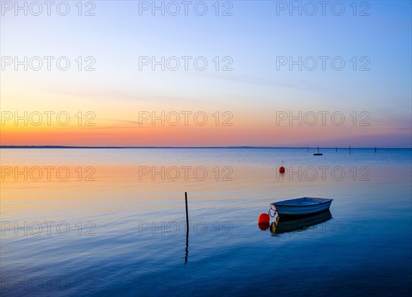 Rowing boat lies in the sea in the evening
