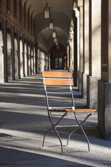 Single folding chair under arcades