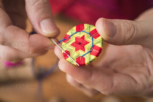 Button maker stitching and wrapping green