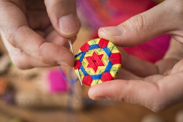 Button maker stitching and wrapping green