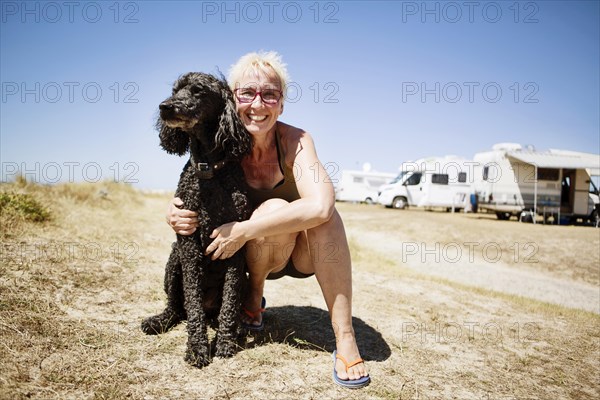 Woman embraces her dog