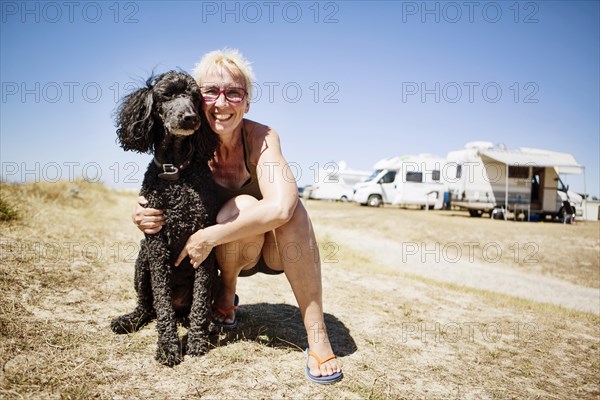 Woman embraces her dog