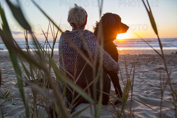 Woman sits with her dog