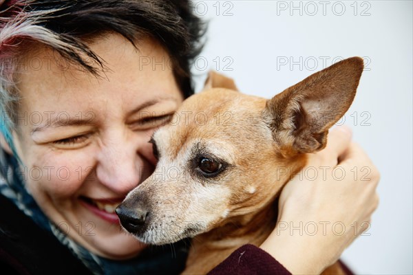 Woman caresses happily her dog