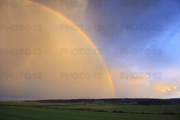 Double rainbow over agricultural landscape