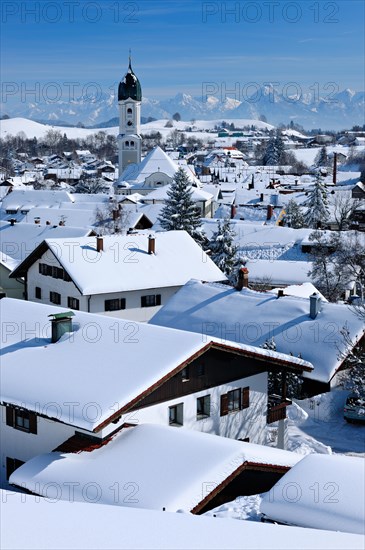 View of snow-covered roofs in winter with St. Andreas church