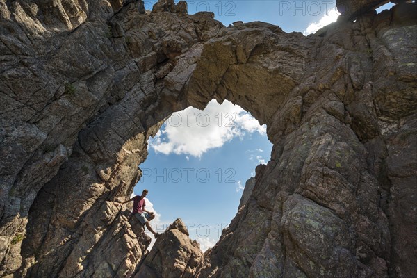 Young man sitting in bomb craters