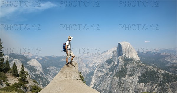 Young man standing on ledge