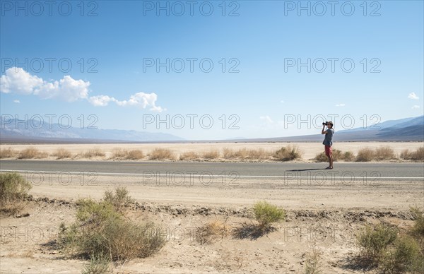 Young man standing on road
