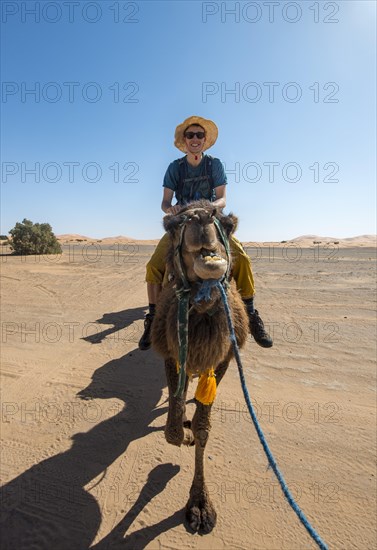 Young man riding on a camel