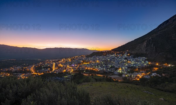 View of illuminated city Chefchaouen at sunset