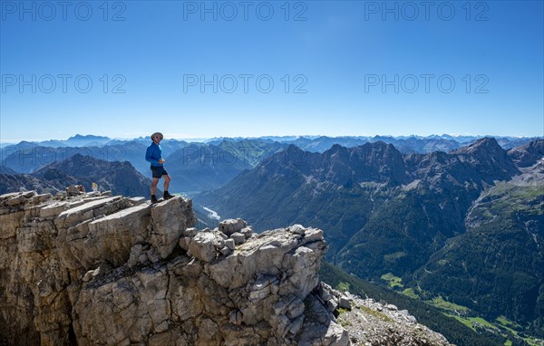 Hiker at the summit of the Hochvogel