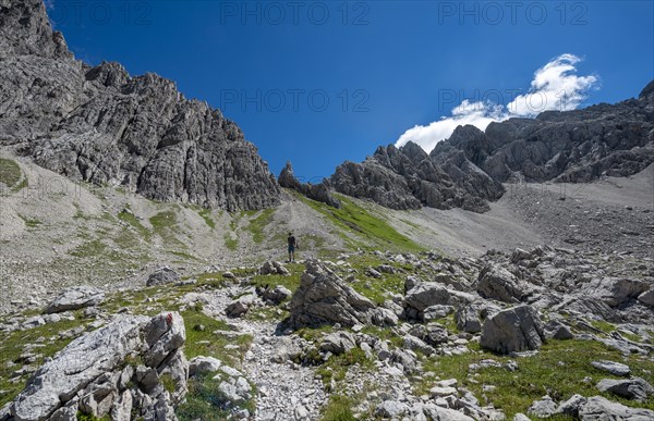 Hiker on hiking trail from Hochvogel to Prinz Luitpold Haus