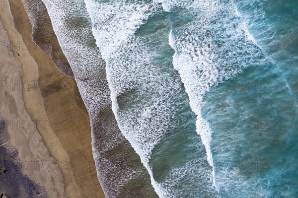 Waves running out at sandy beach