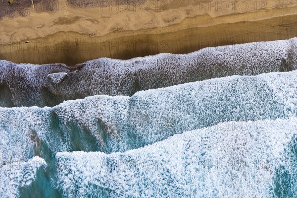 Waves running out at sandy beach