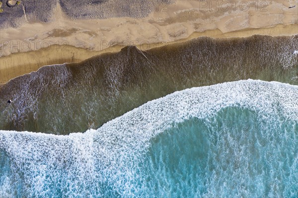 Waves running out at sandy beach