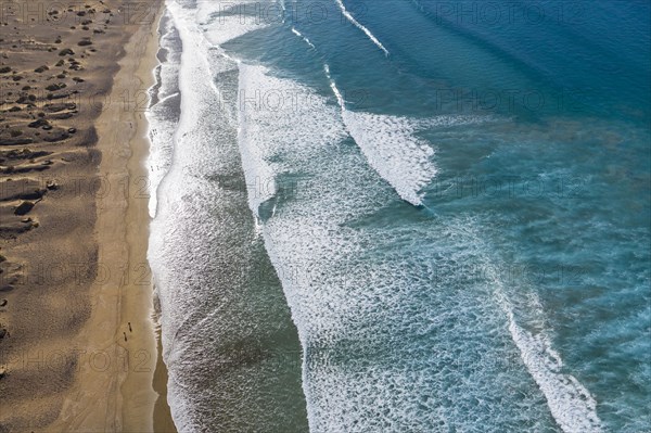 Waves running out at sandy beach