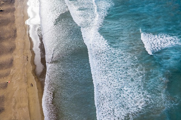 Waves running out at sandy beach