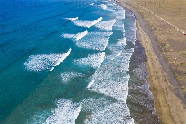 Waves running out at sandy beach