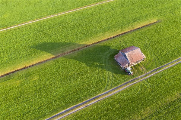 Meadows with barn and tractor