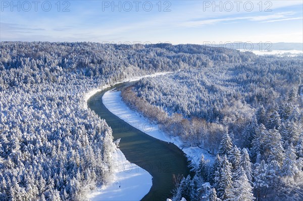 Isar meanders through snow-covered forest area