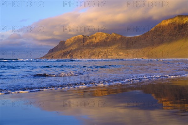Beach at evening light with reflection
